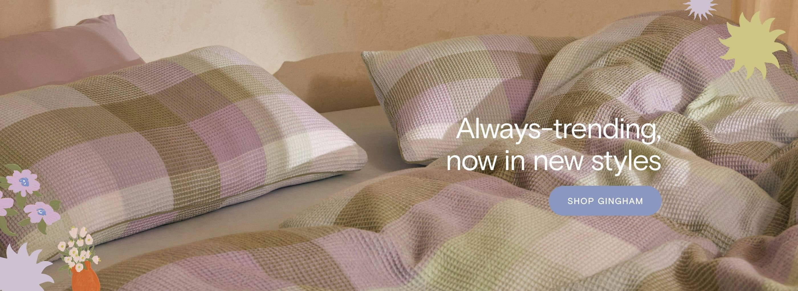 A bed styled with Sheet Society’s new Mia Tully Cotton Waffle pillowcases, quilt cover, and a sky fitted sheet. The text overlay reads, 'Always-trending, now in new styles, shop now.